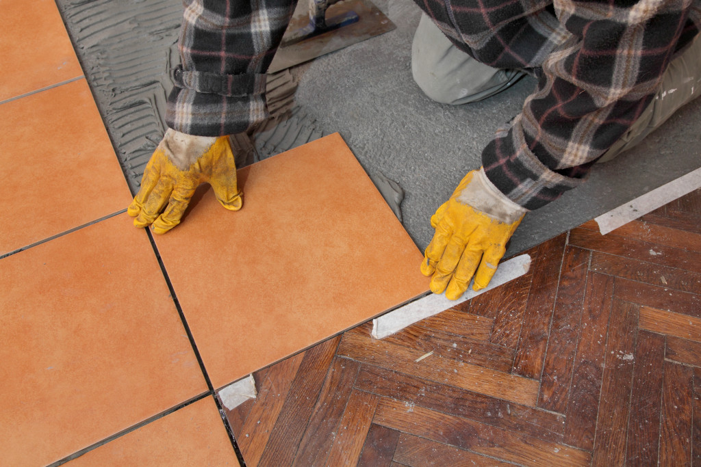 person putting tiles