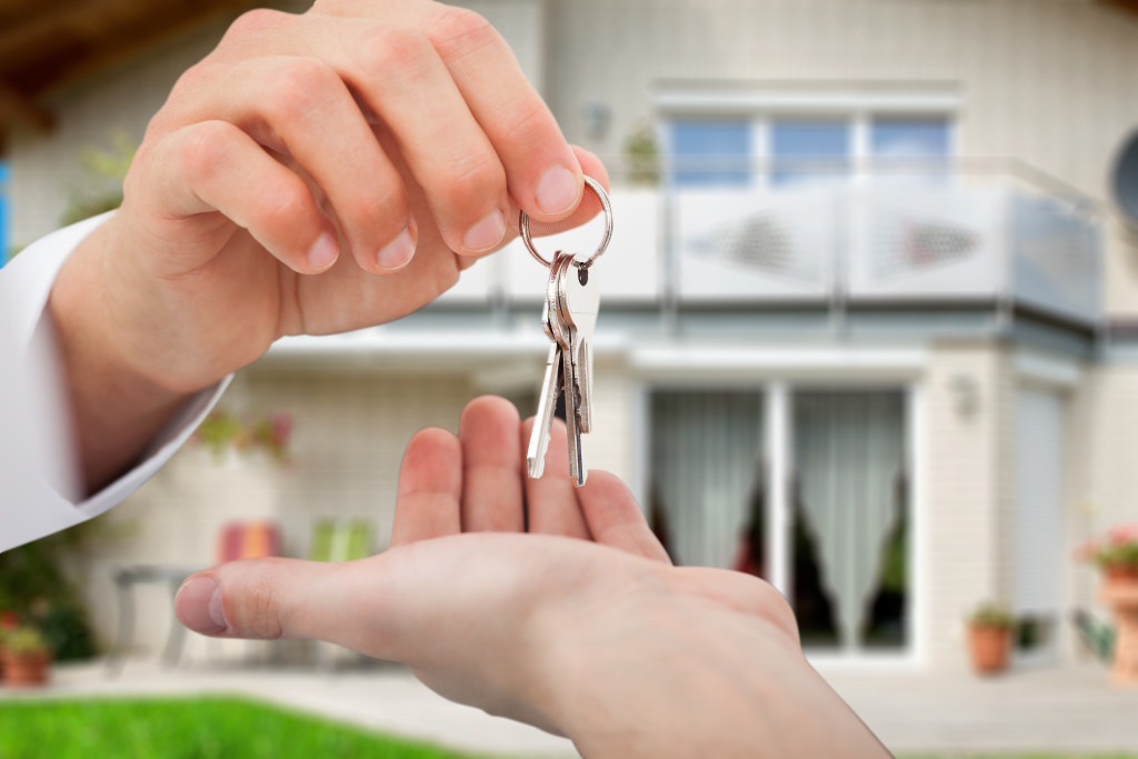 agent handing over a house key