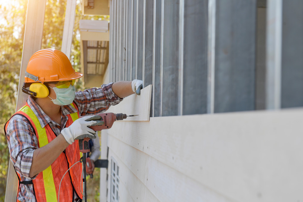A construction worker working on wall panels